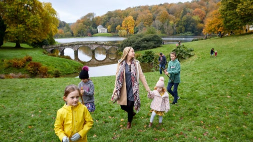 A family enjoys Stourhead's renowned autumn colour